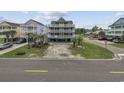 Three story beach house on stilts features multiple decks and covered parking at 510 S Ocean Blvd., Surfside Beach, SC 29575