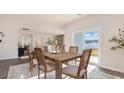 Comfortable dining room with wood table, four chairs, and natural light from the sliding glass door at 5163 Yellowstone Dr., Conway, SC 29526