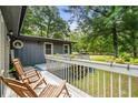 Scenic view from the porch, complete with rocking chairs and a view of the green lawn at 532 Medcalf Dr. Sw, Sunset Beach, NC 28468