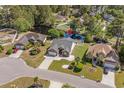 Aerial view of a home with a pond-view backyard, surrounded by lush greenery at 615 Woodbine Ct., Myrtle Beach, SC 29579