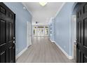 Inviting foyer with light blue walls, light floors, and a view of the living area at 615 Woodbine Ct., Myrtle Beach, SC 29579