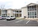 Charming condo building with screened porches, well-kept landscaping, and designated parking spots at 6204 Sweetwater Blvd. # 6204, Murrells Inlet, SC 29576