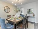 Elegant dining room with decorative wallpaper, modern light fixture, and seating for six guests at 822 Belle Dr., North Myrtle Beach, SC 29582