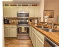 Cozy kitchen featuring stainless steel appliances, tile backsplash, and wood countertops at 1221 Tidewater Dr. # 1922, North Myrtle Beach, SC 29582