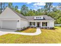 Beautiful one-story home with a manicured lawn and inviting front porch, perfect for relaxation at 1274 Pinetucky Dr., Galivants Ferry, SC 29544