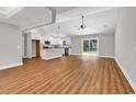 Open-concept living room with hardwood floors, modern ceiling fan, and sliding glass doors at 1274 Pinetucky Dr., Galivants Ferry, SC 29544