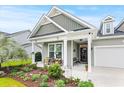 Charming single-story home featuring a covered front porch and manicured landscaping at 129 Astoria Park Loop, Conway, SC 29526