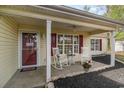 Cozy covered front porch with rocking chairs, stylish accents, and a welcoming entrance at 550 Crusade Circle, Conway, SC 29526