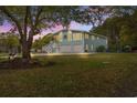 Charming two-story home with a spacious driveway and two-car garage with large tree at 67 Kingsbury Pl., Georgetown, SC 29440