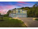 Charming two-story home with a spacious driveway and two-car garage at dusk at 67 Kingsbury Pl., Georgetown, SC 29440