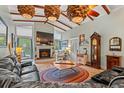Spacious living room with high ceilings, fireplace, and plush leather seating at 67 Kingsbury Pl., Georgetown, SC 29440