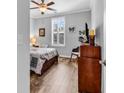 Cozy bedroom with hardwood floors, a ceiling fan, bright natural light, and neutral wall color at 1000 Oak Marsh Ln., North Myrtle Beach, SC 29582