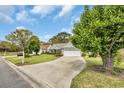 Inviting single-story home with a well-maintained lawn and a long driveway leading to the attached garage at 1292 Merion Ct., Murrells Inlet, SC 29576