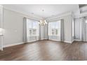 Bright dining area with hardwood floors, chandelier, and large windows at 1312 Ashboro Ct., Myrtle Beach, SC 29579