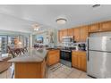 Bright kitchen features stainless steel appliances and a breakfast bar overlooking the living room at 1605 S Ocean Blvd. # 1114, Myrtle Beach, SC 29577