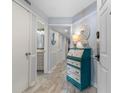 Bright foyer with stylish decor, wood-look floors, and a glimpse into the bathroom at 180 Rothbury Circle # 203, Myrtle Beach, SC 29572
