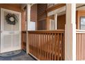 Inviting front porch featuring white door with lavender wreath, unit number, and wood railing at 180 Rothbury Circle # 203, Myrtle Beach, SC 29572