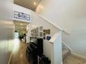 Bright hallway with a piano, staircase and decorative wall hangings at 187 S Reindeer Rd., Surfside Beach, SC 29575