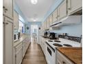 Galley kitchen with sleek countertops, traditional appliances and a view of the breakfast nook at 211 76Th Ave. N # A-2, Myrtle Beach, SC 29572