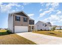 View of the exterior of a two-story home with a two-car garage and long driveway at 2639 Riverboat Way, Conway, SC 29526