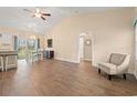 Open-concept living space with wood floors, a dining area, and a cozy chair in the corner at 2827 Allen Dew Rd., Conway, SC 29527