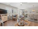 Bright living room with ceiling fan, wicker accents and large windows at 323 14Th Ave. S # B, Surfside Beach, SC 29575