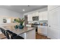 Bright kitchen featuring granite countertops, stainless steel appliances, and a breakfast bar with seating at 327 Glade Ct., Loris, SC 29569