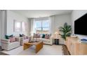 Inviting living room with large windows, stylish furnishings, and neutral decor, perfect for relaxation at 327 Glade Ct., Loris, SC 29569