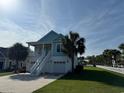 Charming two-story coastal home with a white picket fence and lush green lawn at 3851 Journeys End Rd., Murrells Inlet, SC 29576