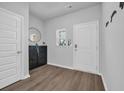 Bright foyer features wood-look flooring, storage bench, and a decorative mirror at 4105 Da Vinci Dr., Myrtle Beach, SC 29579