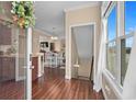Inviting entryway with hardwood floors leads to a dining area and staircase with natural light shining through at 4387 Landing Rd., Little River, SC 29566