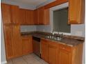 Well-lit kitchen with modern sink, stainless steel dishwasher, and ample countertop space at 4664 Southgate Pkwy., Myrtle Beach, SC 29579