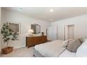 Bright bedroom featuring a comfy bed, wood dresser with a mirror and decor, and a leafy plant near framed artwork at 478 Blissful Ln., Little River, SC 29566