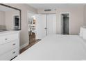 Cozy bedroom featuring neutral walls and white trim, offering a serene retreat with glimpses into adjacent rooms at 4800 S Ocean Blvd. # 1103, North Myrtle Beach, SC 29582
