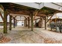 Spacious covered carport area offering parking and storage with concrete flooring and wooden support beams at 6001 - 1125 S Kings Hwy., Myrtle Beach, SC 29575