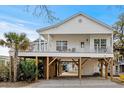Charming elevated home with a spacious porch and covered parking at 6001- L08 S Kings Hwy., Myrtle Beach, SC 29575