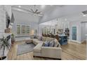 Open-concept living room featuring a large sectional couch, a fireplace, and a view into the kitchen at 805 East Coast Ln., North Myrtle Beach, SC 29582