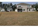 Expansive backyard featuring a covered patio and ample space for recreation at 1304 Winding Creek Way, Myrtle Beach, SC 29588