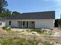 Back of house with white siding and covered porch under gray roof at 1395 Knotty Branch Rd., Conway, SC 29527