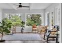 Bright sunroom with large windows offering serene outdoor views and stylish furniture arrangement at 1625 Deer Park Ln., Surfside Beach, SC 29575