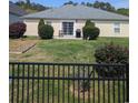 Fenced backyard with mature plantings, grassy area, and patio at 320 Mckaylas Ct., Myrtle Beach, SC 29579
