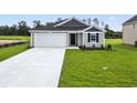 Beautiful single-Gathering home featuring lush green lawn and concrete driveway at 33 Cape Point Dr., Conway, SC 29527