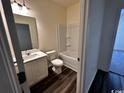 Well-lit bathroom featuring a shower and tub combination and modern fixtures at 623 Castillo Dr., Loris, SC 29569