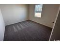Cozy bedroom featuring neutral carpet and a window for natural light at 623 Castillo Dr., Loris, SC 29569