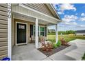 Inviting front porch with seating area, a perfect spot to enjoy the outdoors at 1390 Highway 129, Galivants Ferry, SC 29544