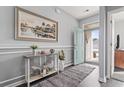 Welcoming entryway with a stylish console table, hardwood floors, and an inviting open door at 1612 Cosmos Lane, Myrtle Beach, SC 29577