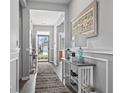 Elegant entryway featuring hardwood floors, console table and a serene view of the home's exterior at 1612 Cosmos Lane, Myrtle Beach, SC 29577