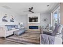 Comfortable living room featuring a cozy sofa, electric fireplace, and a soothing color scheme at 1612 Cosmos Lane, Myrtle Beach, SC 29577