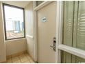 Condo hallway with unit number 4065, a window, door, and tile floors at 201 75Th Ave N # 4065, Myrtle Beach, SC 29572