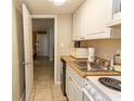 Small kitchen with oven, sink, microwave, cabinets and a doorway to the living room at 201 75Th Ave N # 4065, Myrtle Beach, SC 29572